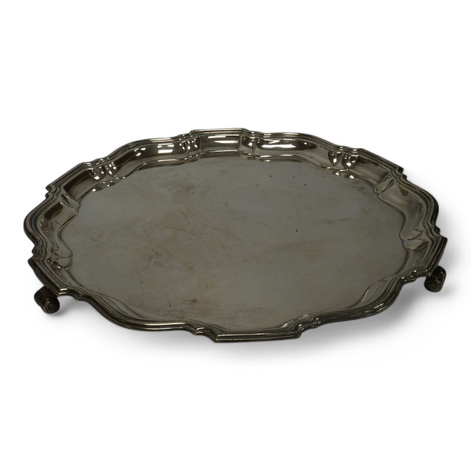 A George VI silver salver, with pie crust border, on three scroll feet, by Barker Brothers Silver Ltd, Birmingham, 1936, 30.7cm, 31.3oz. Condition - fair to good